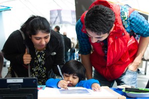 Visitors to the Adler Planetarium participate in a Zooniverse hands-on activity during Earthfest